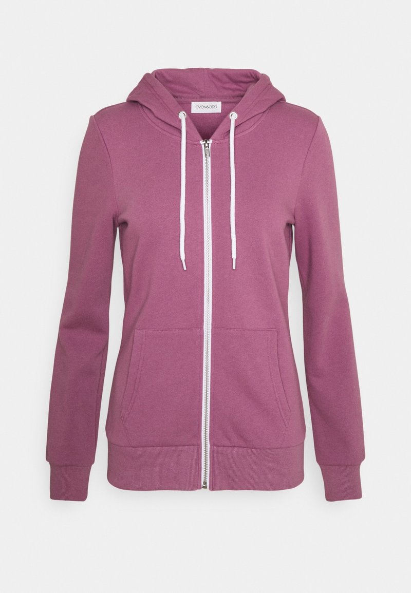 Felpa con zip di un color viola medio, realizzata in tessuto morbido. Presenta un cappuccio, lacci bianchi e due tasche frontali con polsini a coste.
