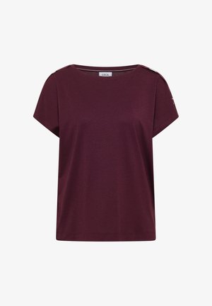 Top femme à manches courtes de couleur violet foncé avec encolure bateau et détail bouton à l'épaule, étiquette indiquant "CECIL" à l'intérieur du col.