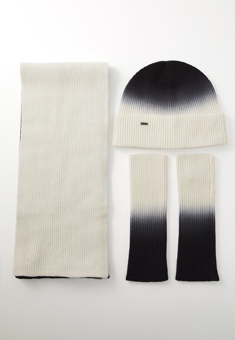 Strikket hue, tørklæde og armvarmere i en creme- og sort ombre-mønster. Ribbet tekstur, blødt materiale, praktisk til koldt vejr.