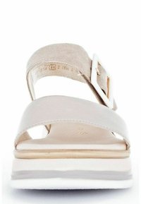 Beige sandal featuring two wide straps, a textured suede finish, a round buckle detail, and a layered, cushioned sole.