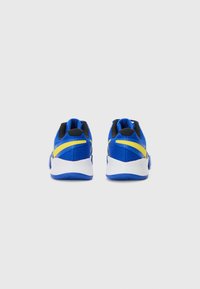 Blue athletic shoes featuring a textured mesh upper, black accents, and yellow stripes. White soles with a blue tread pattern.