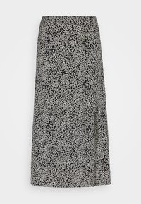 Jupe midi noire et blanche avec un motif abstrait de lignes ondulées, coupe droite, sans ornements ni fermetures visibles.
