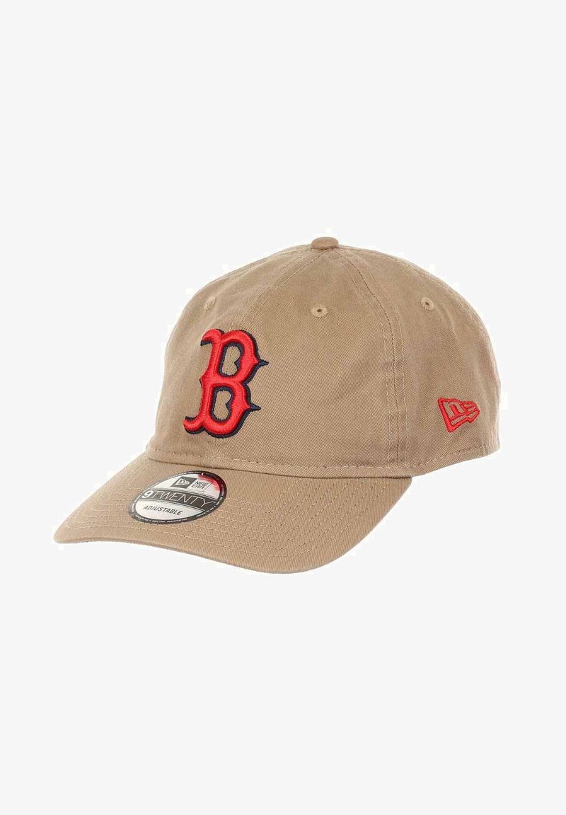 Khaki baseball cap with red and navy embroidered "B" logo. Features a curved brim, adjustable strap, and fabric texture. New Era branding tag included.