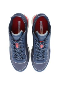 Navy blue sneakers with a smooth upper, contrasting white sole, textured laces, and red accents featuring the U.S. Polo Assn. logo.