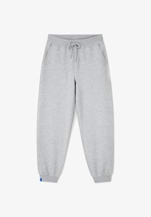 Szare spodnie dresowe wykonane z miękkiego materiału, z elastycznym pasem ze sznurkiem, bocznymi kieszeniami oraz ściągaczami przy kostkach.