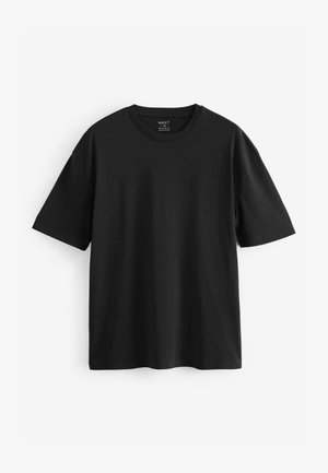 Juodas medvilninis marškinėliai su trumpomis rankovėmis, apvalia iškirpte ir laisvu stiliumi. Lygi tekstūra, nematomi raštai ar akcentai.