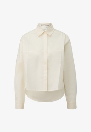 Chemise boutonnée à manches longues, couleur crème, avec col, patte de boutonnage frontale et ourlet légèrement incurvé. Fabriquée en tissu lisse.