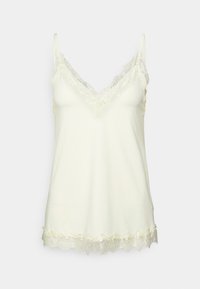 Krämfärgad satinlinne med spetsdetaljer vid halsringning och nederkant, med tunna justerbara axelband.