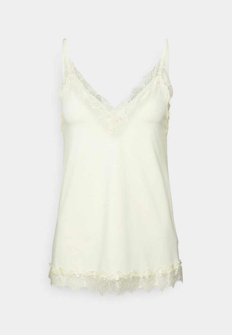 Krämfärgad satinlinne med spetsdetaljer vid halsringning och nederkant, med tunna justerbara axelband.