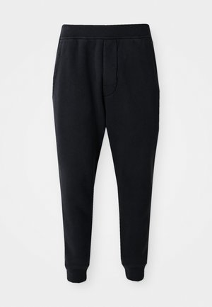 Black tapered jogger pants with elastic waistband, side pockets, and cuffed ankles on a white background.