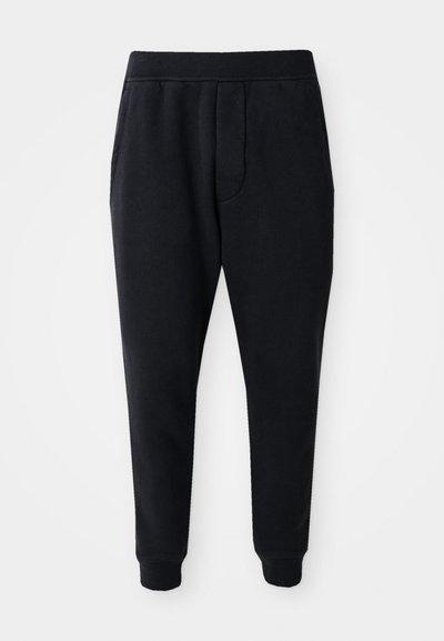 Black tapered jogger pants with elastic waistband, side pockets, and cuffed ankles on a white background.