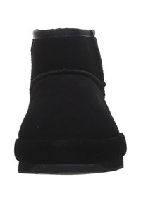Botas de tobillo de ante negro con punta redondeada, textura suave, detalle de costura mínima y suela de goma. Carece de adornos adicionales.