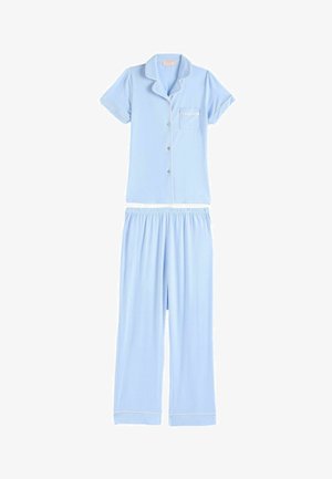 Vaaleansininen lyhythihainen läpivetoketjullinen pyjamapaita valkoisella reunuksella ja siihen sopivat väljästöiset housut kuminauhavyötäröllä ja valkoisella reunuksella.
