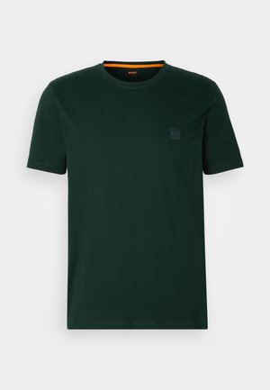 Dark green cotton t-shirt featuring a crew neck, short sleeves, and a small black logo patch on the chest. Smooth texture, classic fit.