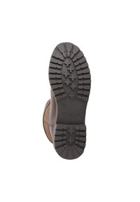 Bruine laars gezien vanuit de zool, met een diep profielpatroon met kruisvormige en rechthoekige noppen voor grip.