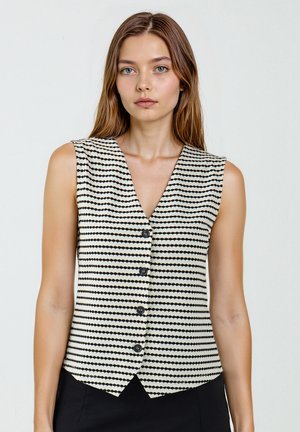 Zwart-witte gestreepte mouwloze vest met een V-hals, voorzien van een knoopsluiting aan de voorkant en een lichte flare aan de onderkant. Getextureerde stof.