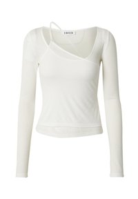 Witte lange mouwtop met geribbelde textuur, asymmetrische halslijn en een uitsnijdetail op de schouder. Etiket zegt "EDITED."