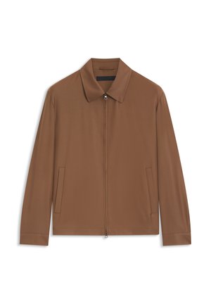 Veste marron zippée avec col pointu et poches latérales, présentée à plat sur un fond blanc.