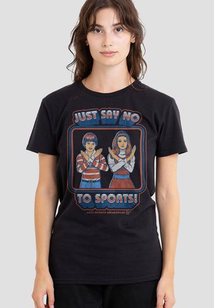 Woman wearing black t-shirt with cartoon boy and girl crossing arms and text "Just say no to sports!" and "Anti-sports awareness."