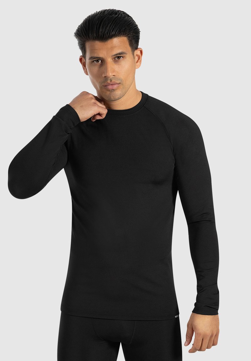 Schwarzes, langärmliges Sportshirt mit Rundhalsausschnitt und Raglanärmeln, aus einem glatten Stoff mit taillierter Passform.