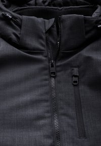 Black weather-resistant jacket with a zippered front, textured fabric, adjustable hood, and zip pocket detail on the left chest.