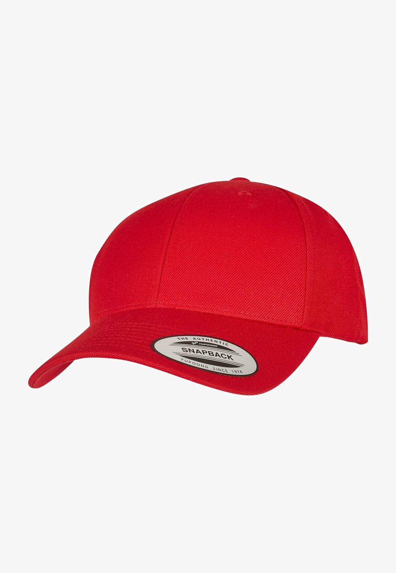 Red snapback cap with a structured design, flat brim, and fabric texture. Features a circular logo patch on the front.