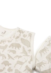 Vêtement sans manches en coton crème à motifs animaliers. Comprend diverses illustrations d'animaux en gris. Doté d'une fermeture éclair sur un côté.