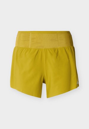 Yellow athletic shorts with a smooth texture, elastic waistband, and a triangular logo accent on the lower right side.