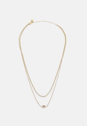 Gold-layered Halskette mit einer glatten Kette und einem kleinen ovalen Anhänger mit einem dekorativen Augendesign. Strukturierte Akzente verleihen Detail.