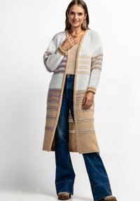 Długi kardigan wykonany z grubego splotu, w beżowe, białe i przygaszone fioletowe paski. Otwarty przód z prążkowanymi mankietami i hemem.