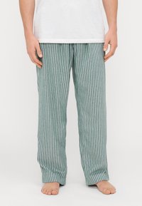 Triibulised pidžaama püksid türkis ja valge, valmistatud kergetest kangast. Omavad lõtvade lõikega, elastse vöökoha ning sirgeid jalgu.