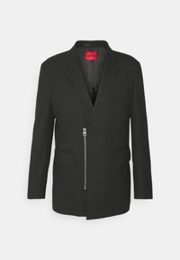 Schwarzer Blazer aus einem Stoff mit glatter Textur, ausgestattet mit einem Reverskragen, einem schrägen Reißverschluss und zwei Fronttaschen.