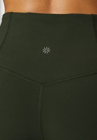 Athleta ELATION FLARE PANT - Leggings - aspen olive