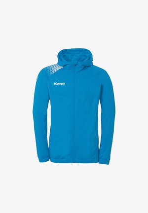 Blå hættejakke med lynlås, lavet af letvægtsmateriale. Har et rutemønster på den ene skulder. Logoet "Kempa" vises fremtrædende.