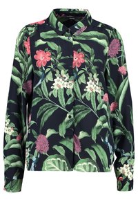 Camicia a maniche corte con bottoni in stile floreale, caratterizzata da uno sfondo blu scuro, grandi foglie verdi, fiori rosa e bianchi, realizzata in un tessuto morbido e leggero.