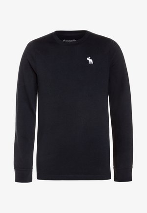 Camiseta negra de manga larga con cuello redondo y pequeño logo blanco de alce en el lado izquierdo del pecho, diseño sencillo, hecha de tela suave.