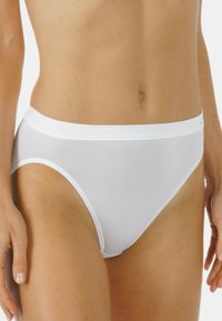 White cotton briefs with a smooth texture, mid-rise waistband, and full coverage design, featuring subtle stitching accents.