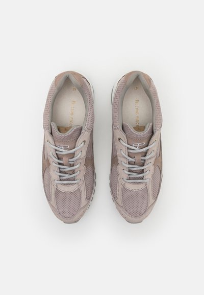 Light grey athletic shoes made of suede and mesh, featuring a lace-up design, perforated texture, and a white rubber sole.