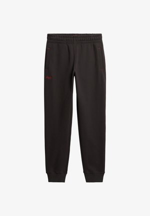 Czarne spodnie dresowe z elastycznym pasem, bocznymi kieszeniami z czerwonym przeszyciem, ściągaczami na kostkach oraz małym czerwonym logo na lewej uda.