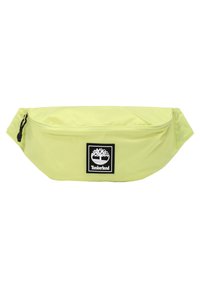 Marsupio Timberland verde chiaro con tasca frontale con zip e etichetta nera con logo raffigurante un albero e il nome del marchio.
