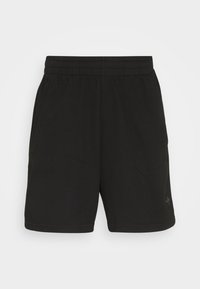 Black athletic shorts with a textured fabric, elastic waistband, and two side pockets, featuring minimal branding on the lower leg.