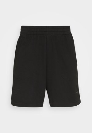 Svarte treningsshorts laget av teksturert stoff, med elastisk midje og to sidelommer, som har minimal merking på den nedre delen av leggen.