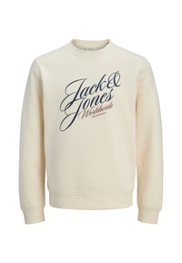 Sudadera de color crema con cuello redondo, mangas largas y puños acanalados. Presenta un logo en escritura azul marino en el frente. Textura suave.