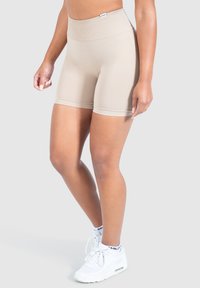 Beige hoge taille shorts met een gladde textuur en een elastische tailleband, ontworpen voor comfort en actieve inzet.
