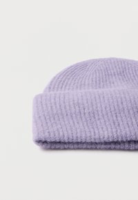 Purple knit beanie with a ribbed texture and folded hem. Made of soft, fuzzy material, featuring a solid color without patterns or accents.