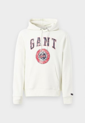 Valge kapuutsiga sviiter, mis on valmistatud puuvillase segust, esiosa kangaroo tasku, reguleeritav kapuuts, suur "GANT" graafika ja kulunud embleemi disain.