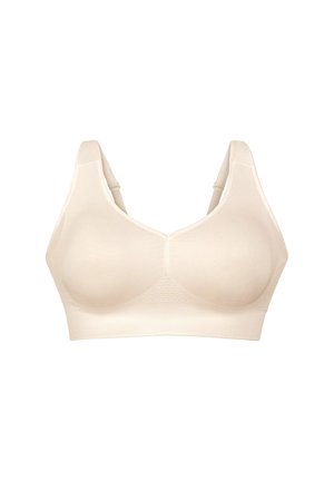Nahtloser beiger kabelloser BH mit breiten, verstellbaren Trägern, geformten Cups und einem stützenden elastischen Bund am unteren Rand.