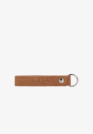 Brown suede leather keychain with a metal ring and snap button, embossed with "Quali Leder studio" on a white background.