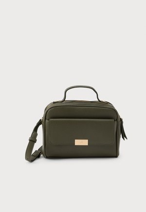 Green leather bag with a structured shape, front pocket, gold-tone hardware, and a detachable strap. Textured surface with zipper closure.