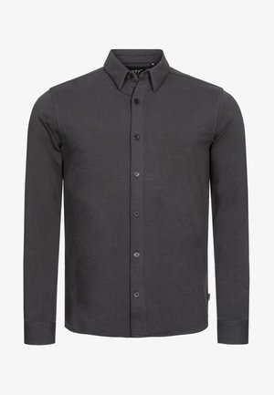Tmavo šedá košeľa s dlhými rukávmi a gombíkmi vyrobená z bavlny. Obsahuje klasický límec, prednú gombíkovú légou a manžety na jeden gombík.